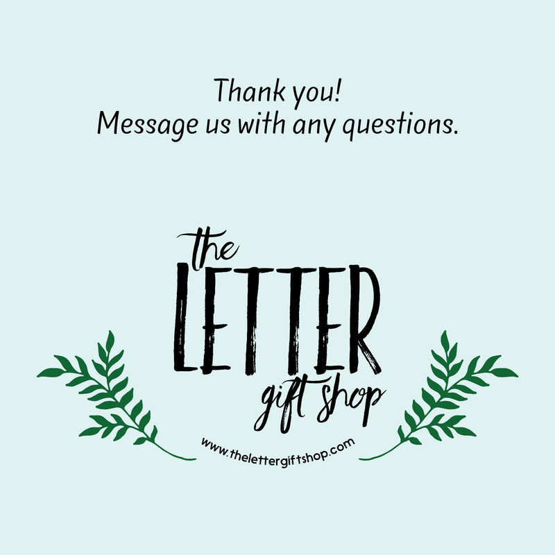 The image is a graphic design for a gift shop called &quot;The Letter gift shop&quot;. It features a stylized text &quot;The Letter&quot; in a decorative font, surrounded by green leaves. The text also includes a message that says &quot;Thank you! Message us with any questions.&quot; The website &quot;www.thelettered GIFTSHOP.com&quot; is also displayed. The image is a simple, clean design with minimal text and decorative elements.