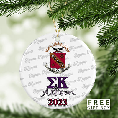 May include: A white round Christmas ornament with a purple and white Sigma Kappa sorority crest. The ornament has the letters &#39;ΣΚ&#39; in purple and the name &#39;Allison&#39; in purple script. The year &#39;2023&#39; is written in maroon below the name. The ornament is surrounded by a repeating pattern of the words &#39;Sigma Kappa&#39; in a gray script.