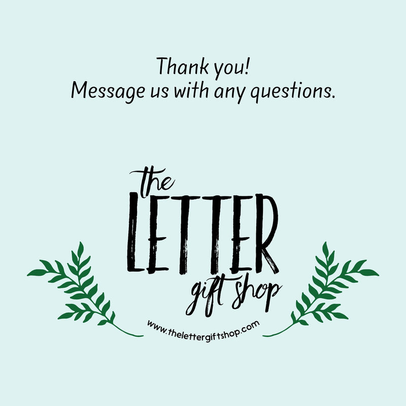 The image is a graphic design for a gift shop called "The Letter gift shop". It features a stylized text "The Letter" in a decorative font, surrounded by green leaves. The text also includes a message that says "Thank you! Message us with any questions." The website "www.thelettered GIFTSHOP.com" is also displayed. The image is a simple, clean design with minimal text and decorative elements.